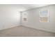 Sun-filled bedroom with neutral carpet, dual windows, and a clean, blank canvas for personalization at 25096 N 154Th Ln, Surprise, AZ 85387