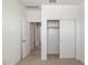 A bedroom features open closet doors and views of an adjoining bathroom with a sliding door at 25096 N 154Th Ln, Surprise, AZ 85387