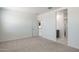 Bright bedroom shows open door to kitchen and open door to bathroom with dark wood vanity at 25096 N 154Th Ln, Surprise, AZ 85387