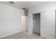 Neutral carpeted bedroom with closet, white walls, and trim at 25096 N 154Th Ln, Surprise, AZ 85387