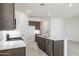 Modern kitchen boasts white quartz counters, stainless steel appliances, and ample cabinet storage space at 25096 N 154Th Ln, Surprise, AZ 85387