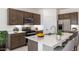 Modern kitchen featuring stainless steel appliances, a spacious island, and contemporary cabinetry at 25096 N 154Th Ln, Surprise, AZ 85387