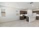 Bright and modern kitchen with an open floor plan; featuring white quartz countertops and a kitchen island at 25096 N 154Th Ln, Surprise, AZ 85387