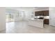 Open concept kitchen with island, stainless appliances, and sliding doors to the outdoor patio at 25096 N 154Th Ln, Surprise, AZ 85387