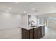 Bright, open kitchen with a modern island, stainless steel dishwasher, and large open living area at 25096 N 154Th Ln, Surprise, AZ 85387