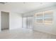 Well-lit living area with a large window and sliding glass door that brings in plenty of natural light at 25096 N 154Th Ln, Surprise, AZ 85387