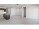 Open living space with recessed lighting and an adjacent kitchen features an island and stainless appliances at 25096 N 154Th Ln, Surprise, AZ 85387
