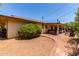 Backyard featuring gravel, brick path, covered patio, and lush landscaping at 2716 S Terrace Rd, Tempe, AZ 85282