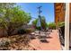 This private backyard offers a charming seating area surrounded by lush greenery and vibrant flowers at 2716 S Terrace Rd, Tempe, AZ 85282