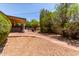 Inviting backyard with brick patio, gravel, mature trees, and covered seating area at 2716 S Terrace Rd, Tempe, AZ 85282