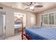 Inviting bedroom features vanity, ceiling fan, and large window for plenty of sunlight at 2716 S Terrace Rd, Tempe, AZ 85282