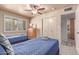 This inviting bedroom offers two twin beds and a light-filled ambiance with shuttered windows at 2716 S Terrace Rd, Tempe, AZ 85282