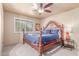 Cozy bedroom with plush carpet, ceiling fan, and abundant natural light from the large window at 2716 S Terrace Rd, Tempe, AZ 85282