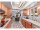 Bright kitchen boasts wood cabinets, tiled floors and countertops, open layout to the living area at 2716 S Terrace Rd, Tempe, AZ 85282