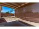 Covered back patio with shade provides a relaxing outdoor living space overlooking the serene backyard at 330 S Valley Dr, Apache Junction, AZ 85120