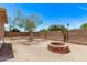 Spacious backyard featuring a charming brick fire pit, perfect for outdoor gatherings and relaxation at 330 S Valley Dr, Apache Junction, AZ 85120
