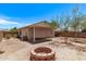 Expansive backyard features a cozy brick fire pit and a covered patio for outdoor enjoyment at 330 S Valley Dr, Apache Junction, AZ 85120