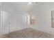 Bright bedroom features plush carpet flooring, closet, and a window at 330 S Valley Dr, Apache Junction, AZ 85120