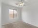 Bright bedroom features carpet, a window, and a ceiling fan at 330 S Valley Dr, Apache Junction, AZ 85120