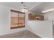 Dining area featuring a decorative light fixture, window with blinds, and an open view to the kitchen at 330 S Valley Dr, Apache Junction, AZ 85120