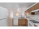 Functional kitchen showcasing tile floors, white appliances, wood cabinets and an open floorplan at 330 S Valley Dr, Apache Junction, AZ 85120