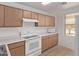 Kitchen area showcasing white appliances, wood cabinets, ample counter space, and tile floors at 330 S Valley Dr, Apache Junction, AZ 85120