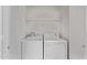 Bright laundry room features a washer, dryer, and shelving for convenient storage and organization at 330 S Valley Dr, Apache Junction, AZ 85120