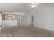 Open-concept living space showing the kitchen and a nearby utility closet, with neutral carpet at 330 S Valley Dr, Apache Junction, AZ 85120