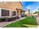 Spacious backyard features a covered patio, lush lawn, and play area, perfect for outdoor enjoyment at 34913 N 30Th Dr, Phoenix, AZ 85086