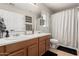 This bathroom includes double sinks and a shower with a white shower curtain at 34913 N 30Th Dr, Phoenix, AZ 85086