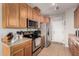 Efficient kitchen featuring stainless steel appliances, wood cabinets and tile flooring at 34913 N 30Th Dr, Phoenix, AZ 85086