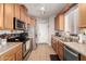 Well-equipped kitchen with stainless steel appliances and tile flooring, ideal for cooking at 34913 N 30Th Dr, Phoenix, AZ 85086