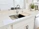Close up of kitchen sink with sleek faucet and bright countertops at 34913 N 30Th Dr, Phoenix, AZ 85086