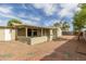 Backyard with a covered patio, shed, desert landscaping, and block fencing for privacy at 3802 N 50Th Ave, Phoenix, AZ 85031