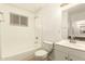 An all-white bathroom with a bath and shower combination and a tiled floor at 3802 N 50Th Ave, Phoenix, AZ 85031