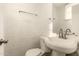 Traditional-style half bath with white brick walls, toilet, and sink at 3802 N 50Th Ave, Phoenix, AZ 85031