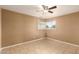 An empty bedroom features tiled floors, tan walls, and a ceiling fan at 3802 N 50Th Ave, Phoenix, AZ 85031