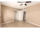 A bright room with tiled floors, neutral walls, a ceiling fan and a closet at 3802 N 50Th Ave, Phoenix, AZ 85031