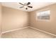 An empty room with tiled floors, neutral walls, a ceiling fan, and natural lighting at 3802 N 50Th Ave, Phoenix, AZ 85031