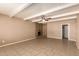 This living room features a ceiling fan, tile flooring, and a stone fireplace at 3802 N 50Th Ave, Phoenix, AZ 85031