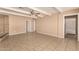 Spacious living room featuring tile flooring, a stone fireplace, and neutral paint at 3802 N 50Th Ave, Phoenix, AZ 85031