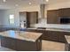 Open concept kitchen with granite countertops, stainless steel appliances, and a central island at 3811 S Bridlewood Ave, Mesa, AZ 85212