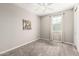 This cozy bedroom features neutral walls, gray carpet, and a ceiling fan at 3910 E Turley St, Gilbert, AZ 85295