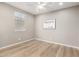 An empty bedroom with hardwood floors features a ceiling fan and neutral colored walls at 3910 E Turley St, Gilbert, AZ 85295