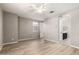 Spacious bedroom with a ceiling fan, light wood flooring, and an en-suite bathroom with a double sink at 3910 E Turley St, Gilbert, AZ 85295