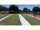 Well-maintained bocce ball court in a community park, surrounded by lush greenery and seating areas at 3910 E Turley St, Gilbert, AZ 85295