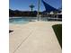 Community pool with a shade structure, clean surrounding concrete, and a splash pad for Gathering fun at 3910 E Turley St, Gilbert, AZ 85295