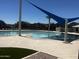 A luxurious community pool featuring a splash pad, lounge seating, and manicured landscaping for resort-style living at 3910 E Turley St, Gilbert, AZ 85295
