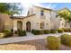 Inviting home exterior with stucco finish, a balcony, and a beautifully landscaped front yard at 3910 E Turley St, Gilbert, AZ 85295