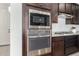 Gourmet kitchen featuring stainless steel oven and microwave, paired with sleek countertops and tile backsplash at 3910 E Turley St, Gilbert, AZ 85295
